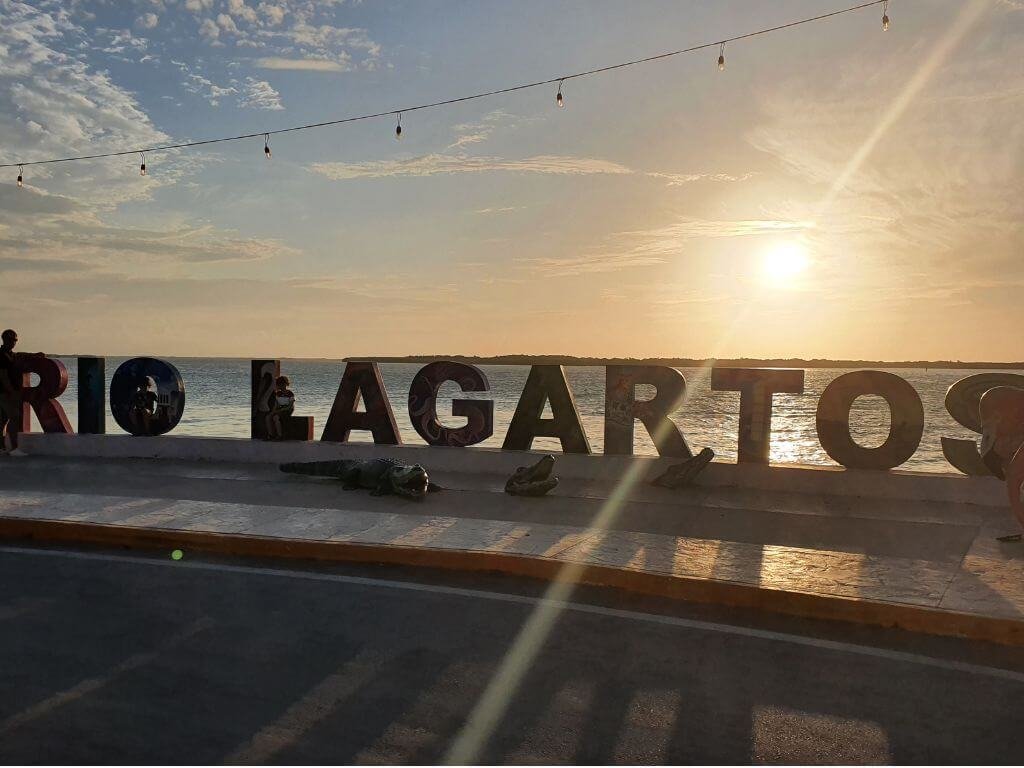 Kinderen poseren bij de kleurrijke Letras Turísticas van Río Lagartos tijdens een vakantie in Mexico met kinderen